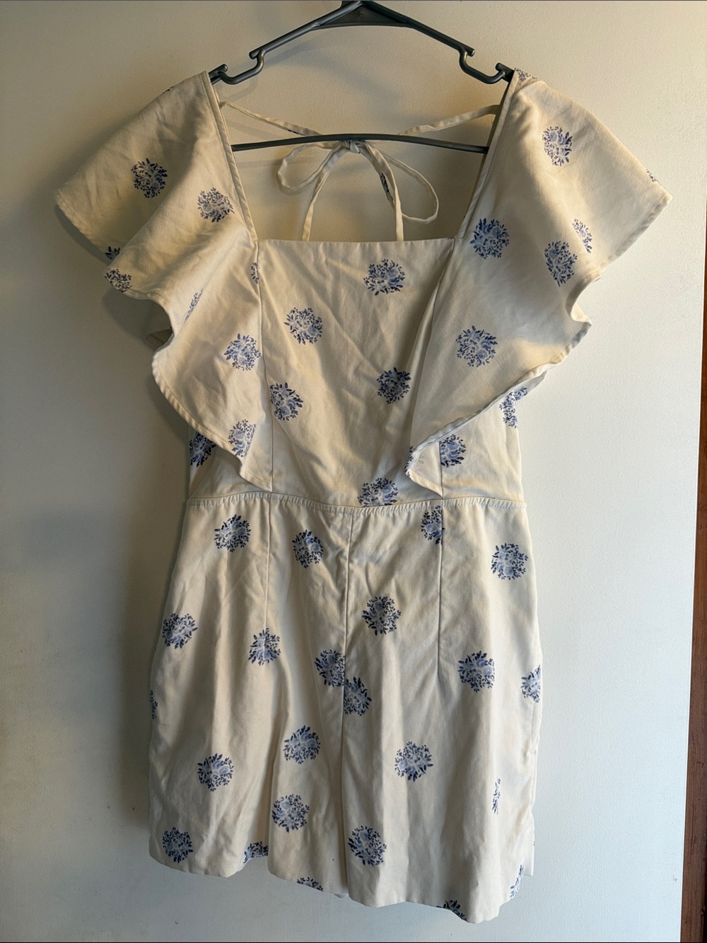 Club Monaco white romper with Blue Floral Motif and Ruffle Shoulders